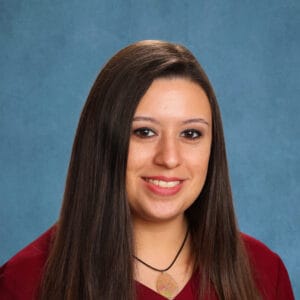 Bright young woman smiling for a professional portrait at The Selwyn School in Austin, TX.