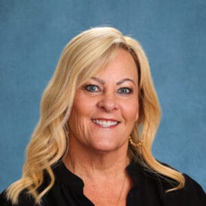 Focused, vibrant portrait of a professional woman representing The Selwyn School, emphasizing leadership and excellence in education.