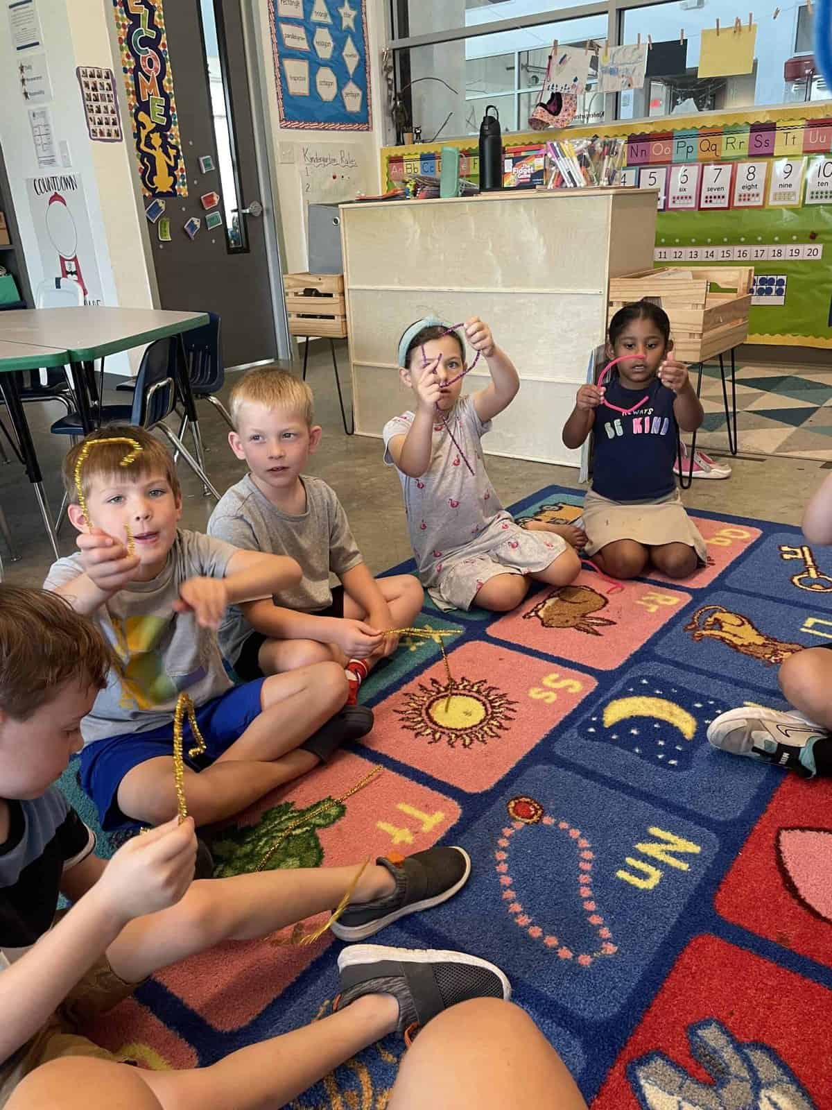Selwyn students sitting cross-legged together on the classroom rug during a group activity.