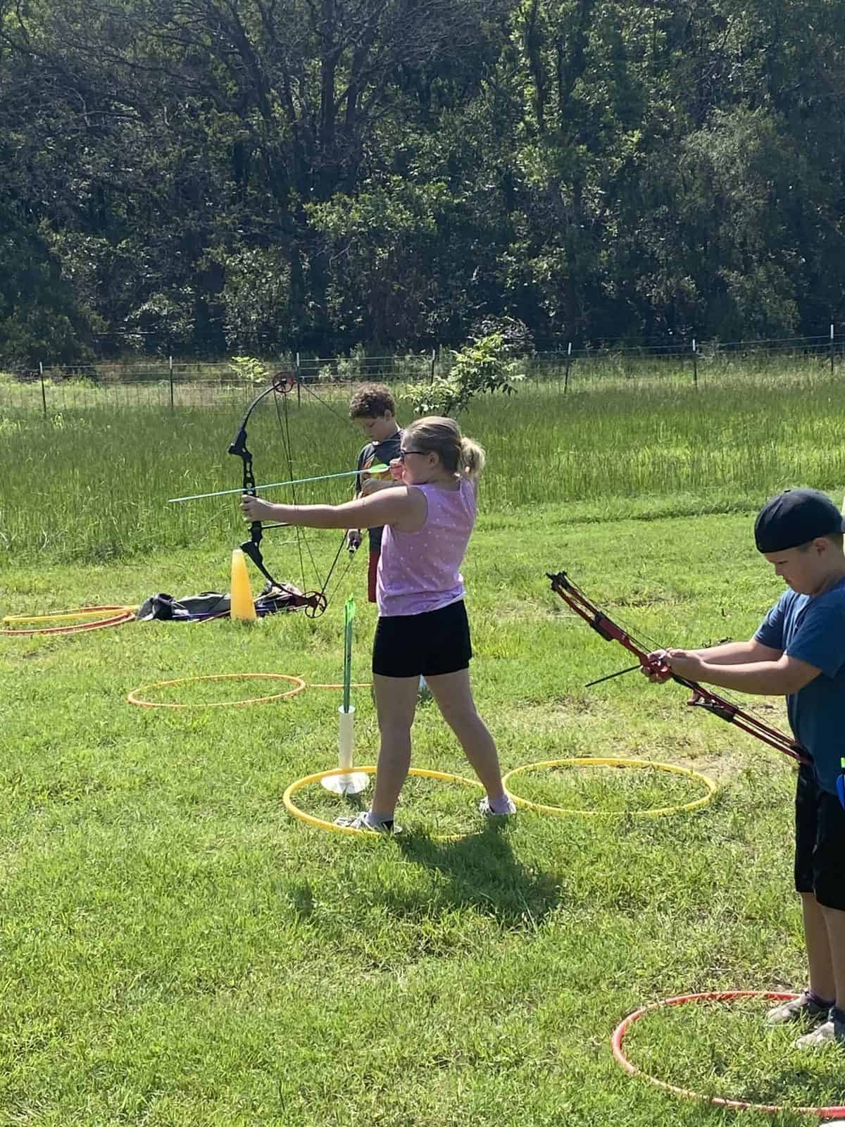 Selwyn students shooting archery in the field on campus